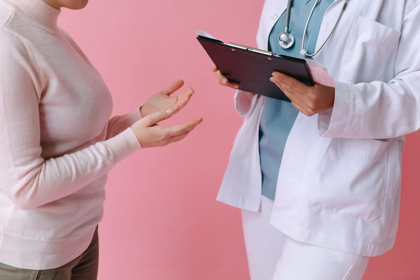 Practitioner listening to a patient in a private consultation