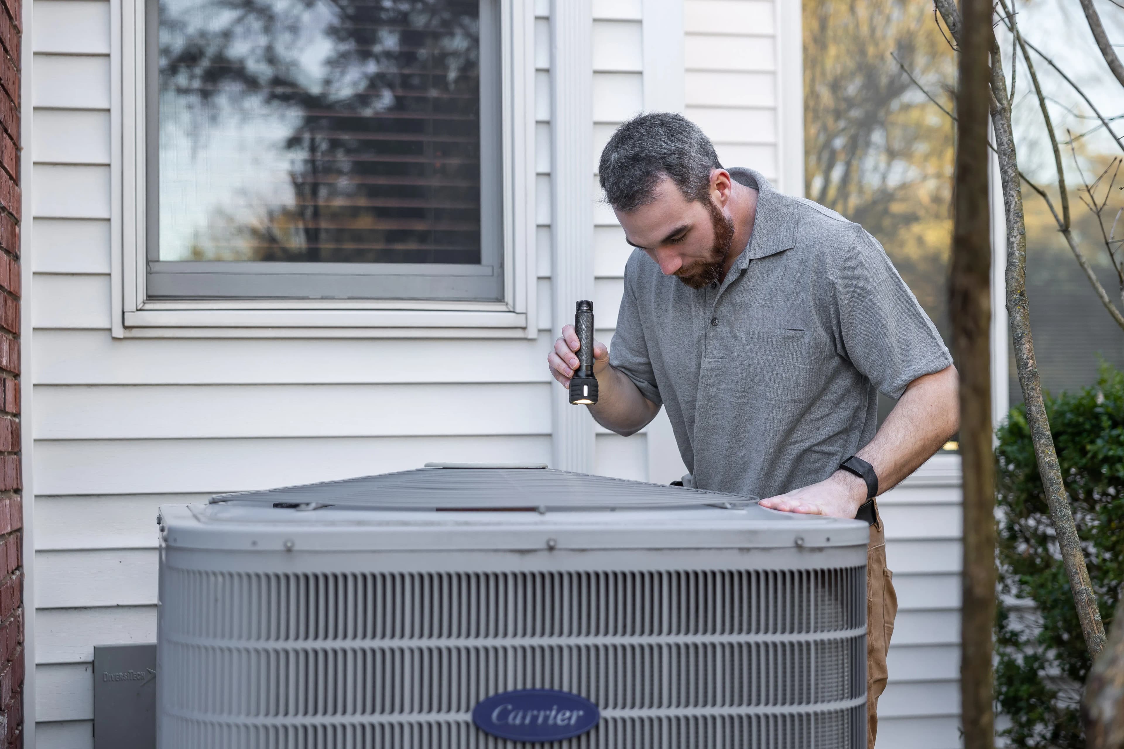 Outdoor AC unit beside green trees